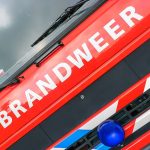 Dutch word 'Brandweer' (fire department) on the engine hood of a fire truck.