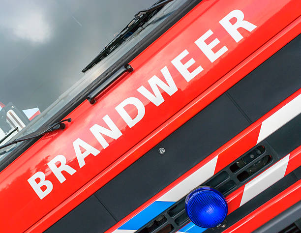 Dutch word 'Brandweer' (fire department) on the engine hood of a fire truck.